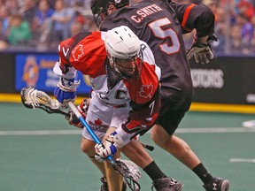 Toronto Rock Colin Doyle (7) is hit by Vancouver Stealth Cliff Smith (5) at the ACC in Toronto March 13, 2016. (Jack Boland/Toronto Sun)