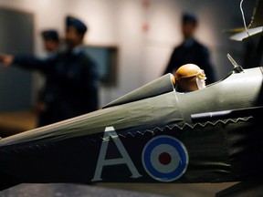 Royal Canadian Air Cadets of 778 Banshee Squadron in Richmond Hill, Ont. walk behind a model of a Tiger Moth, a First World War biplane, at the National Air Force Museum of Canada at CFB Trenton, Ont., Saturday, April 2, 2016. Air crews of the future, present and past often mingle at the museum.