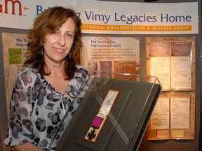 Georgia Sifton, assistant at the Elgin County Museum displays the Victoria Cross awarded to Ellis Sifton.