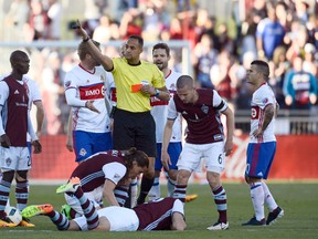 MLS referee Ismail Elfath hands out a red card to Toronto FC midfielder Benoit Cheyrou in the second half of the match against the Colorado Rapid sat Dicks Sporting Goods Park. (Ron Chenoy-USA TODAY Sports)