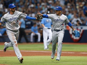 Toronto Blue Jays starting pitcher Marcus Stroman and first baseman Chris Colabello high five at the end of the first inning against the Tampa Bay Rays t Tropicana Field. (Kim Klement/USA TODAY Sports)