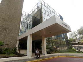 A security guard sit outside the Mossack Fonseca law firm in Panama City, Sunday, April 3, 2016. German daily Sueddeutsche Zeitung says it has obtained a vast trove of documents detailing the offshore financial dealings of the rich and famous. The International Consortium of Investigative Journalism says the latest trove contains includes nearly 40 years of data from the Panama-based law firm, Mossack Fonseca. The company didnít immediately respond to a request for comment. (AP Photo/Arnulfo Franco)