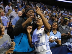 North Carolina's Nate Britt, right, and Villanova's Kris Jenkins celebrate after North Carolina won a regional final men's college basketball game against Notre Dame in the NCAA Tournament in Philadelphia. (AP Photo/Matt Rourke, File)