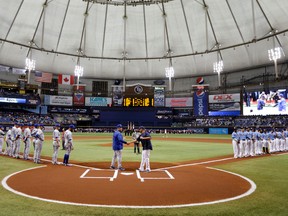 Toronto Blue Jays manager John Gibbons shakes hands with Tampa Bay Rays manager Kevin Cash during player introductions before a baseball game, Sunday, April 3, 2016, in St. Petersburg, Fla.  (AP Photo/Chris O'Meara)