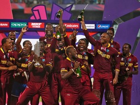West Indies players celebrate with the trophy after winning the Twenty20 final against England. (Reuters)
