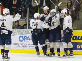 Spruce Grove Saints' Riley Simpson (second from right) celebrates an empty-net goal during an AJHL playoff game against the Lloydminster Bobcats at Grant Fuhr Arena on Friday, April 1, 2016. (Ian Kucerak