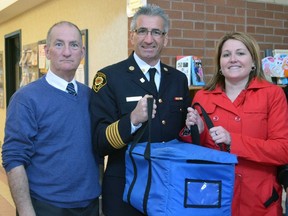 St. Thomas Senior's Centre administrator Dave Warden, left, St. Thomas Fire Chief Rob Broadbent and Mayor Healther Jackson get ready to make their Meals on Wheels deliveries. The local celebrity guests, along with several regular VON volunteers, delivered 39 hot meals people across Elgin county in March. The Mayors for Meals initiative is part of the annual March for Meals awareness campaign.
