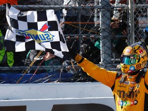 Kyle Busch celebrates winning the Sprint Cup auto race at Martinsville Speedway on Sunday, April 3, 2016, in Martinsville, Va. (AP Photo/Steve Helber)
