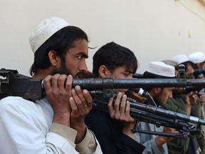 Taliban fighters hold their weapons before surrendering them to Afghan authorities in Jalalabad, east of Kabul, Afghanistan, Sunday, March 27, 2016.  (AP Photo/Mohammad Anwar Danishyar)