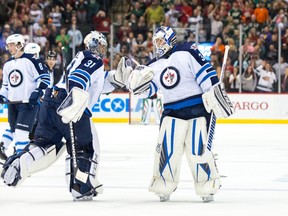 Winnipeg Jets goalie Michael Hutchinson (34) relieves goalie Ondrej Pavelec (31).