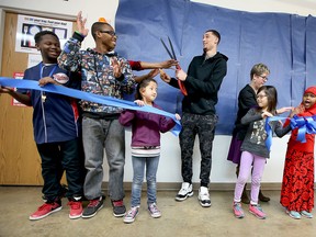 innesota Timberwolves guard Zach LaVine cuts a blue ribbon to showcase a new kitchen for the Metro Deaf School in St. Paul, Minn., Monday, April 4, 2016. (Elizabeth Flores/Star Tribune via AP)