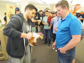 Charles Asselin of Beau's Brewery is shown in this file photo pouring a sample for Andrew Pryor during the Beer Show held last year at the Bayside Centre in Sarnia. This year's Beer Show is set for May 6 and 7. (File photo/Sarnia Observer/Postmedia Network)