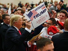 U.S. Republican presidential candidate Donald Trump signs autographs after speaking during a town hall event at the La Crosse Center in La Crosse, Wisconsin April 4, 2016. (REUTERS/Kamil Krzaczynski)
