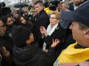 Premier Kathleen Wynne talks with Black Lives Matter protesters at Queen's Park on Monday April 4, 2016. (Craig Robertson/Toronto Sun)