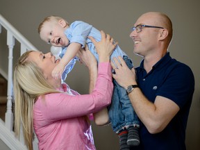 Marissa German, left, and Michael German, right, play with their two-year old son Aiden in their home in Calgary, AB., on Monday, April 4, 2016. Aiden was kept alive by NICUs oxygen machine. (Photo by Andy Maxwell Mawji/Postmedia)