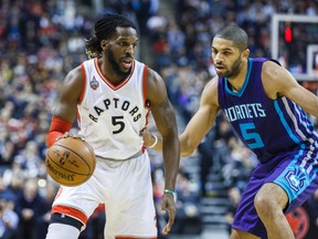 Toronto Raptors forward DeMarre Carroll drives past Charlotte Hornets’ Nicolas Batum during NBA action in Toronto on Friday January 1, 2016. (Ernest Doroszuk/Toronto Sun/Postmedia Network)