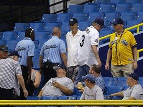 A Tampa Bay Rays fan (3) is removed by security after interfering with a fly ball by Toronto Blue Jays’ Josh Thole Monday, April 4, 2016, in St. Petersburg, Fla. (AP Photo/Chris O’Meara)