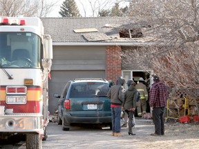 Firefighters clean up at an early morning fire at a home at 3283 Greenbank Road, near Jockvale in Barrhaven on April 5, 2016, (JULIE OLIVER/POSTMEDIA)