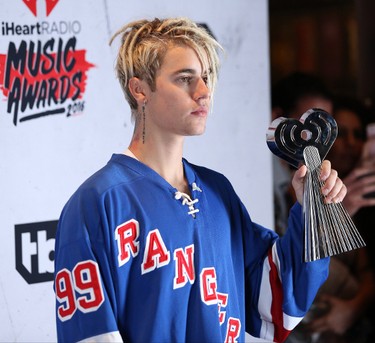 Justin Bieber shows off his new dreadlocks at the iHeartRadio Music Awards in Los Angeles, California. (Brian To/WENN.COM)