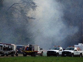Emergency personnel work at the scene after a sightseeing helicopter crashed near Sevierville, Tenn., on April 4, 2016. Officials said several people died when the helicopter crashed near the Great Smoky Mountains National Park. (AP Photo/Wade Payne)