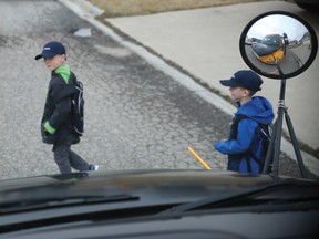 Zachary and William Baker wait for the their bus driver's instructions before crossing the street to board. However, other drivers have been cruising past the buses while their amber lights are flashing and Sheryl Baker — the boys' mother — is concerned about her children's safety. April has now been crowned bus safety awareness month to remind drivers and pedestrians to be safe.