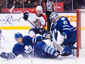 Maple Leafs defenceman Andrew Campbell blocks a shot in front of goalie Jonathan Bernier on Monday night against the Florida Panthers. Campbell had to briefly leave the game after taking a shot in a sensitive area. (The Canadian Press)