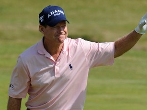 Tom Watson of the U.S. smiles after collecting his ball after hitting a hole in one on the sixth hole during the second round of the British Open golf championship at Royal St George's in Sandwich, southern England July 15, 2011.      (REUTERS/Russell Cheyne)