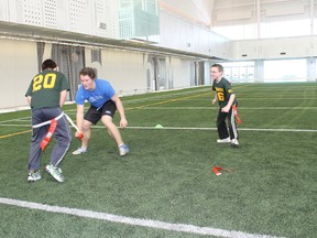 Flag football at Commonwealth Stadium? Absolutely. Among some 400 youngsters in a program conducted jointly by the Edmonton Eskimos, Alberta Golden Bears and Football Alberta, these youngsters on the field at halftime of an Eskimos game, are part of a plan designed to encourage children – some as young as six years old – to develop interest that could carry through club competition and high school play on the way to university teams and, perhaps, professional careers for some. (Supplied)