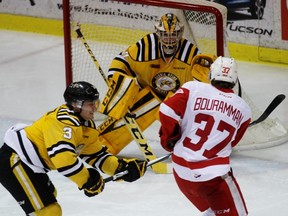 Sarnia Sting goalie Charlie Graham stops a shot from Soo Greyhounds defenceman Gustav Bouramman with Sting defenceman Alex Black defending the play during Game 7 of the Ontario Hockey League Western Conference quarter-final on Tuesday April 5, 2016 in Sarnia, Ont. Terry Bridge/Sarnia Observer/Postmedia Network