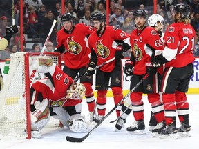 Dejected Senators look on as Pittsburgh Penguins’ Nick Bonino celebrates a goal by the visitors at the Canadian Tire Centre. (Jean Levac, Postmedia Network)