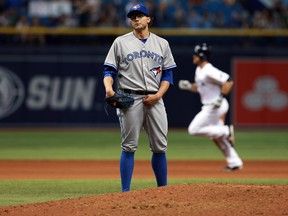 Toronto Blue Jays relief pitcher Brett Cecil reacts as he gave up the go ahead 2 run home run and Tampa Bay Rays second baseman Logan Forsythe runs around the bases during the eighth inning at Tropicana Field. (Kim Klement/USA TODAY Sports)