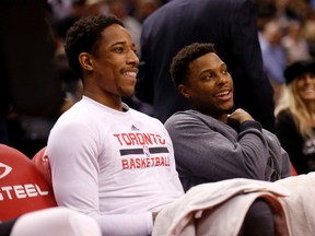 Raptors’ DeMar DeRozan and Kyle Lowry chat on the bench before the start of the game against the Hornets last night. (Michael Peake/Toronto Sun)