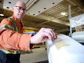 Gino Donato/Sudbury Star
Dan Trottier, lead hand at Rezplast, works on refurbishing the fibreglass on a dragon boat.