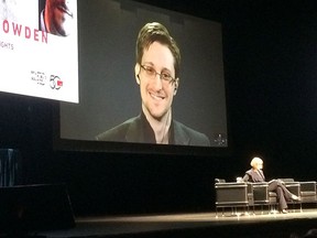 Edward Snowden appears on a live video feed broadcast from Moscow on a panel organized by Simon Fraser University examining the opportunities and dangers of online data gathering at an event in Vancouver on Tuesday, April 5, 2016. THE CANADIAN PRESS/Tamsyn Burgmann