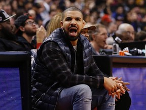 Rapper Drake watches the Toronto Raptors play the Houston Rockets during second half NBA basketball action, in Toronto on Sunday, Mar. 6, 2016. (THE CANADIAN PRESS/Mark Blinch)