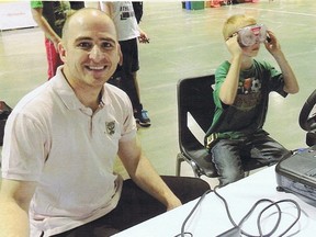 Ali Mohammed (left) has been named volunteer of the year by the Sarnia-Lambton chapter of MADD. A member of the Canadian military, Ali is a former driving instructor. He's shown operating a driving simulator for MADD at a community event.
HANDOUT