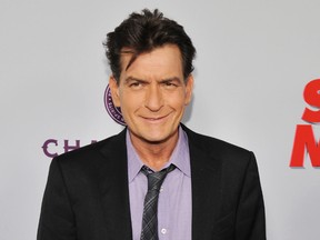 In this April 11, 2013, file photo, Charlie Sheen, a cast member in "Scary Movie V," poses at the Los Angeles premiere of the film at the Cinerama Dome in Los Angeles. (Photo by Chris Pizzello/Invision/AP, File)