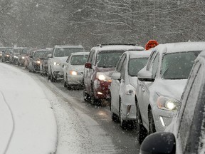 Traffic backed up on Col. By Drive at around 3 p.m. A blanket of snow hit Ottawa midday Wednesday, making the commute difficult on foot and on the roads.