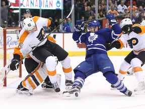 Maple Leafs forward Colin Greening gets taken down during a game against the Flyers on Feb. 20 at Air Canada Centre. Toronto is in Philadelphia on Thursday night. (USA Today Sports)