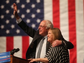 Democratic presidential candidate Sen. Bernie Sanders, I-Vt., waves to the crowd with his wife, Jane Sanders, by his side during a campaign rally Tuesday evening in the Arts and Sciences Auditorium at the University of Wyoming campus. (Blaine McCartney/The Wyoming Tribune Eagle via AP) MANDATORY CREDIT