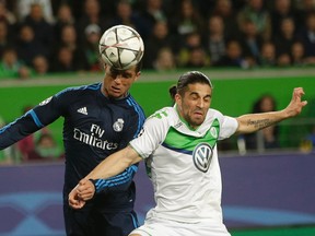 Real Madrid’s Cristiano Ronaldo, left, and Wolfsburg’s Ricardo Rodriguez go for a header during the Champions League quarterfinal in Wolfsburg, Germany, Wednesday, April 6, 2016. (AP Photo/Michael Sohn)