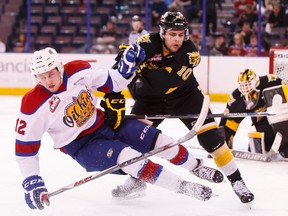 Edmonton Oil Kings' Dario Meyer is taken down by Brandon Wheat Kings' Kale Clague in a WHL series that saw Brandon move on after Game 6 Tuesday. (File)