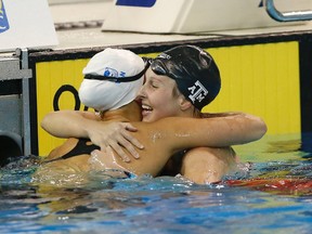 Emily Overholt (left) hugs winner Sydney Pickrem after they qualified for the Rio Olympics with a 1-2 finish in the 400-metre IM at the Toronto Pan Am Sports Centre Wednesday April 6, 2016. (Michael Peake/Toronto Sun/Postmedia Network)