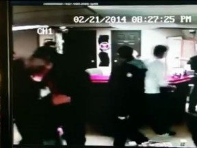 Screen capture of a video showing an attack by some Edmonton members of the Hells Angels on members of the Warlocks MC in a "dustup" in a tattoo studio/laundromat in Drayton Vallery on Feb 21, 2014. (Court video)