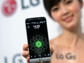 A model poses for photographs with LG Electronics' new smartphone G5 during its launch event in Taipei, Taiwan March 24, 2016. REUTERS/Tyrone Siu