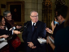 Sen. Jacques Demers speaks to media in the foyer of the Senate on Parliament Hill in Ottawa on Dec. 3, 2015. The Quebec senator and former NHL coach has suffered a stroke. A spokeswoman with his senate office says Demers is in hospital. (THE CANADIAN PRESS/Sean Kilpatrick)