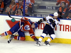 Edmonton Oilers defenceman Oscar Klefbom is checked by St Louis Blues centre Steve Ott during third-period NHL action at Rexall Place in Edmonton on Oct. 15, 2015. (Perry Mah/Edmonton Sun/Postmedia)