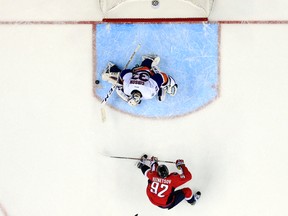 New York Islanders goalie Christopher Gibson blocks a shot by Washington Capitals centre Evgeny Kuznetsov in the overtime period of a game in Washington on April 5, 2016. (AP Photo/Alex Brandon)