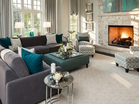 A modern chandelier was added to ceiling pot lights to enhance the design and add lighting to this living room.