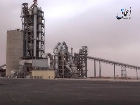 This image made from video published online by Amaq News Agency of the Islamic State group shows a cement factory where in a brazen assault near the Syrian capital, Islamic State militants snatched up to 300 cement workers and contractors from their workplace northeast of Damascus Thursday, April 7, 2016. (militant video via AP)